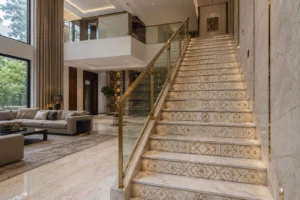 Photorealistic luxury Indian duplex interior featuring a grand contemporary staircase with natural marble treads, custom geometric and floral marble inlay risers with fine brass detailing, glass-and-brass railing, double-height ceiling, and refined neutral-toned living room furniture.