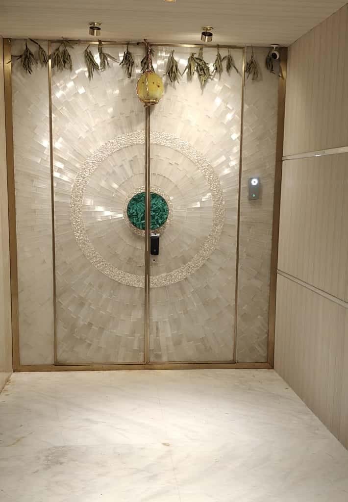 A finished selenite door with green jewel in the middle