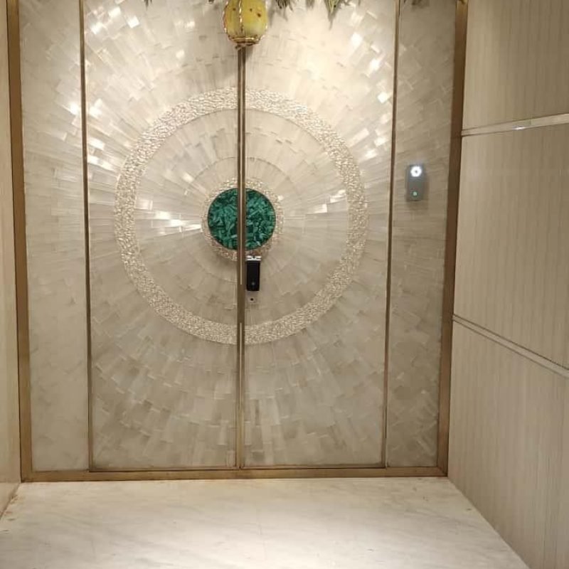 A finished selenite door with green jewel in the middle